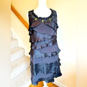 Sleeveless, scoop neck, silver cocktail dress, soft ruffles, jeweled neckline.